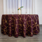 Burgundy round tablecloth with gold foil geometric pattern.