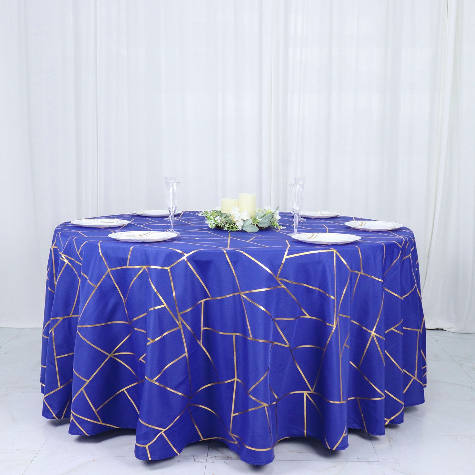 Royal blue tablecloth with gold foil geometric pattern.
