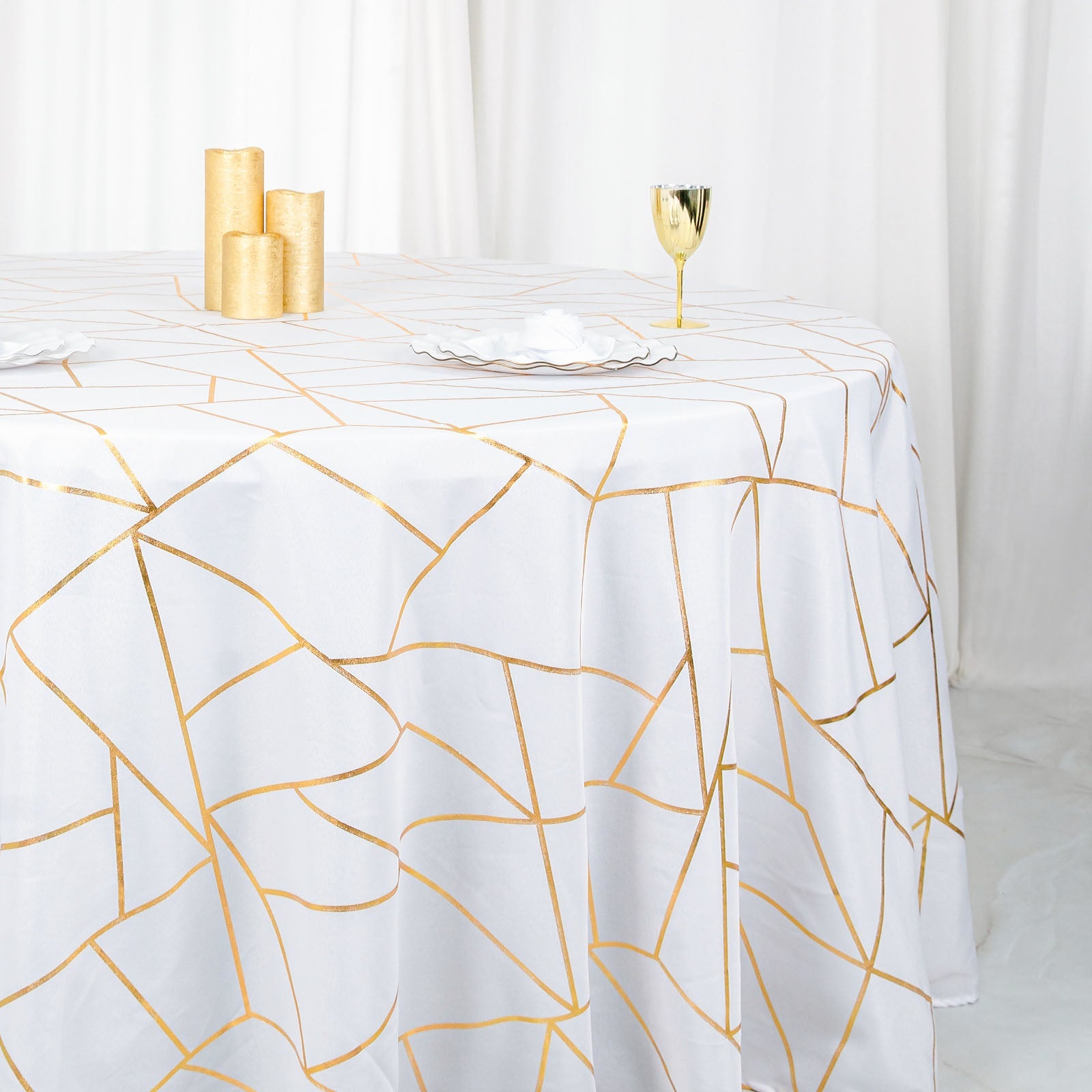 White round tablecloth with gold foil geometric pattern.