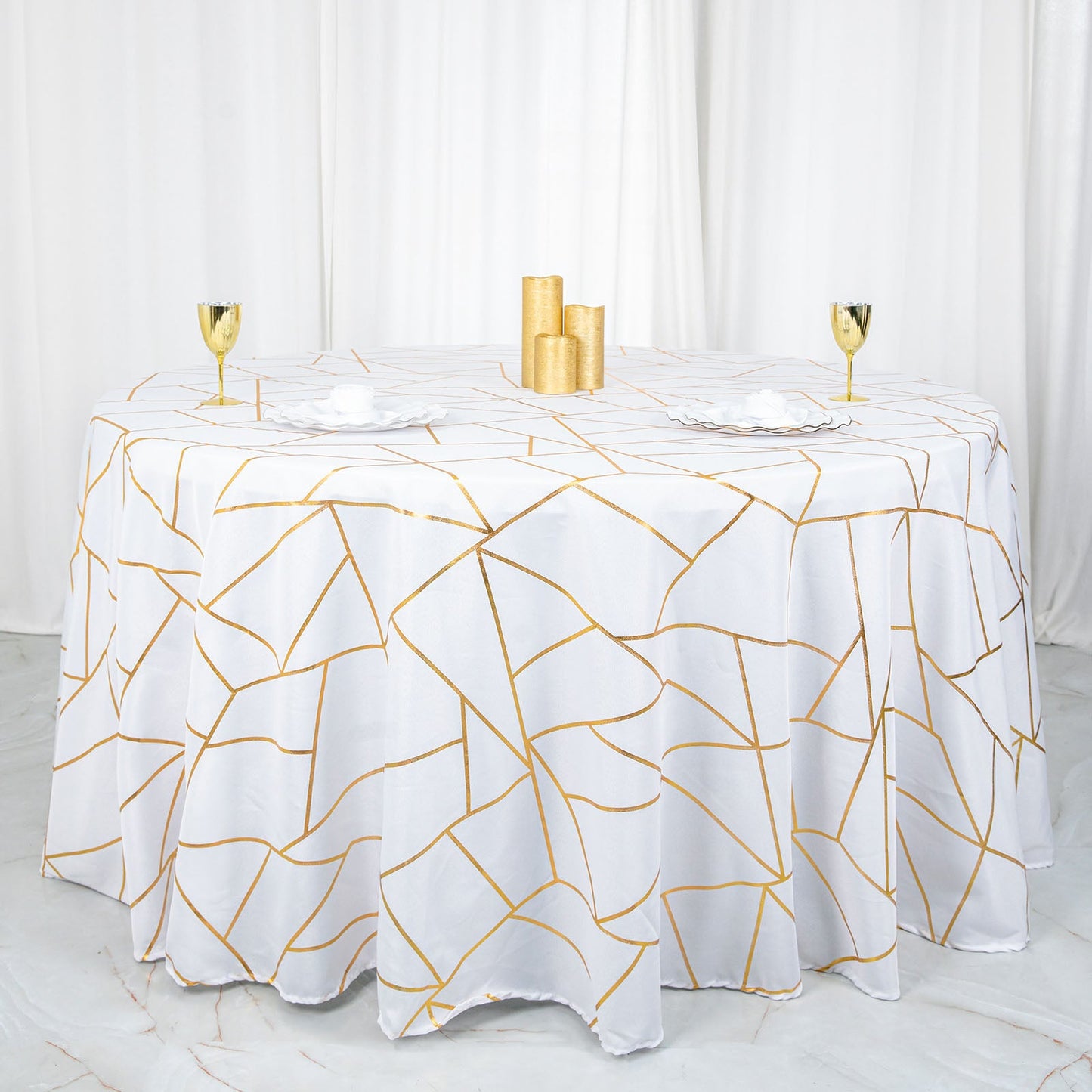 120" white tablecloth with gold foil geometric pattern on a round table.