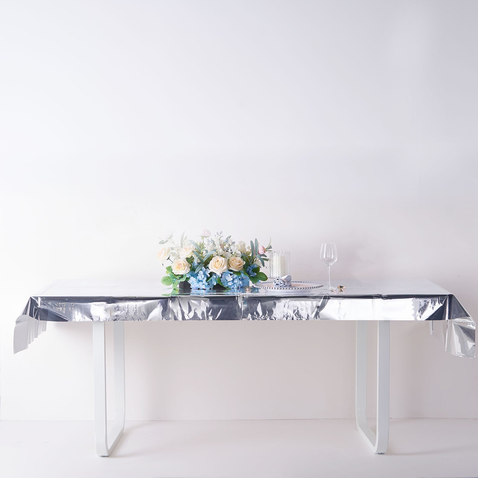 Silver metallic foil rectangle tablecloth on a table.