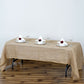 Natural rustic burlap tablecloth on a wooden table with elegant place settings.