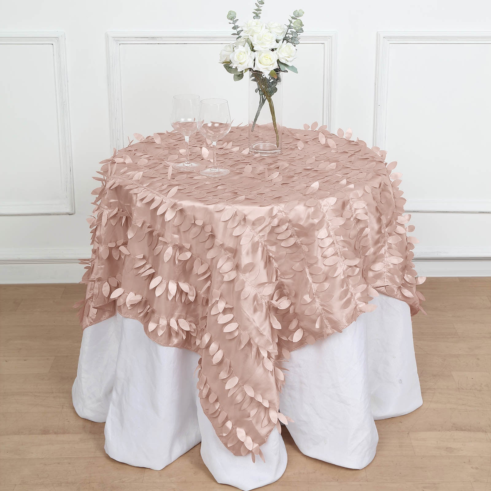 54" Dusty Rose 3D Leaf Petal Taffeta Table Overlay on a white tablecloth.