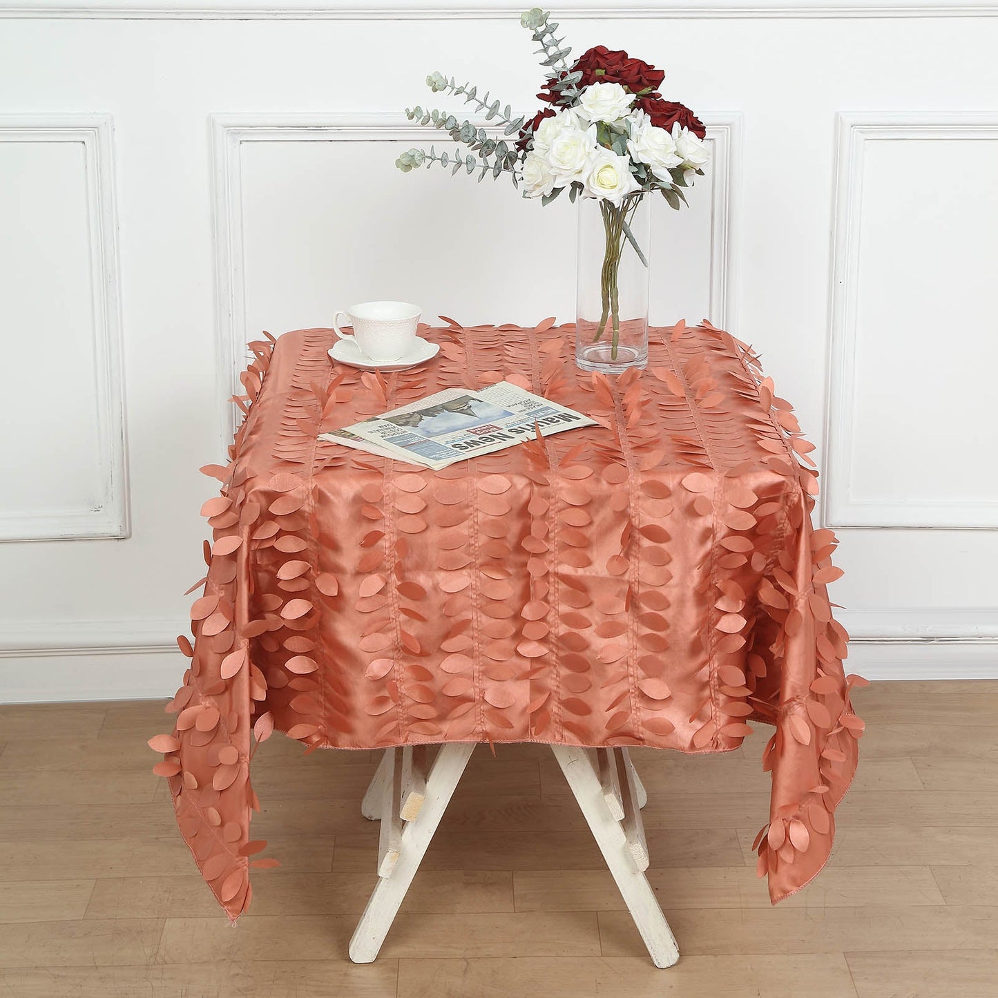 Terracotta 3D leaf petal taffeta table overlay on a square table.