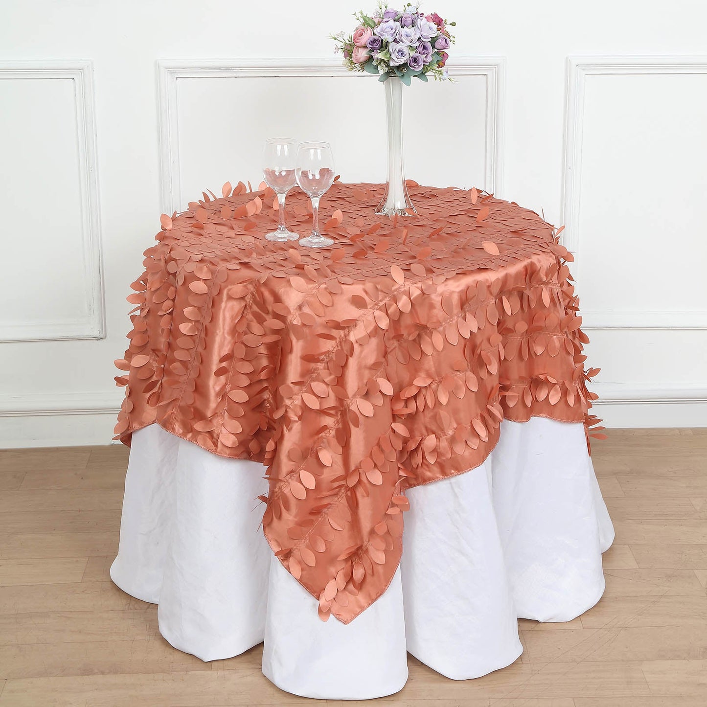 Terracotta 3D leaf petal taffeta table overlay on a round table.