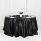 132" black seamless satin round tablecloth on a dining table.