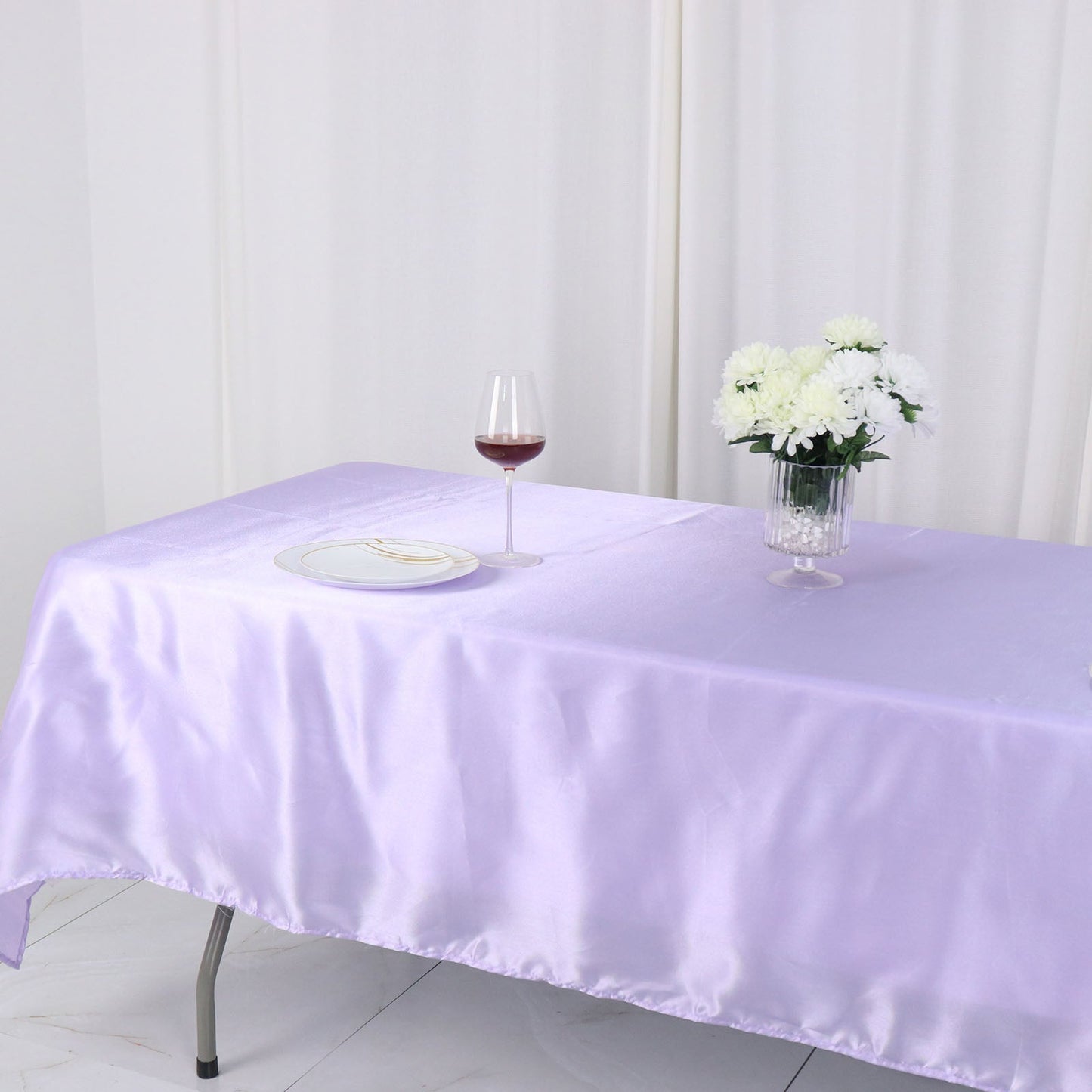 Lavender lilac smooth satin rectangular tablecloth on a dining table.