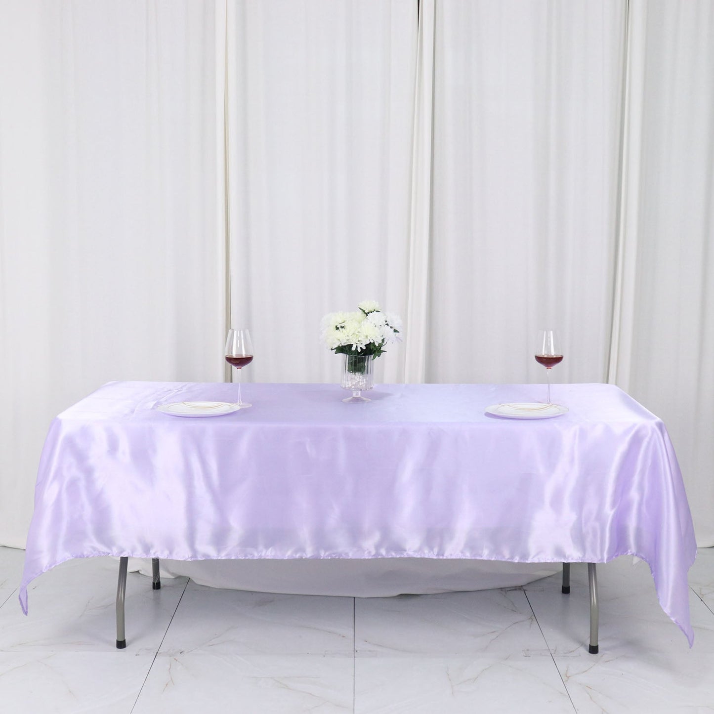 Lavender lilac seamless satin rectangular tablecloth on a table with floral centerpiece.