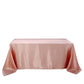 Dusty rose satin rectangular tablecloth on a white background.
