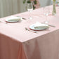 Dusty rose satin rectangular tablecloth on a dining table.