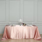 Dusty rose satin rectangular tablecloth on a dining table.