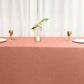 Terracotta satin rectangular tablecloth on a dining table.