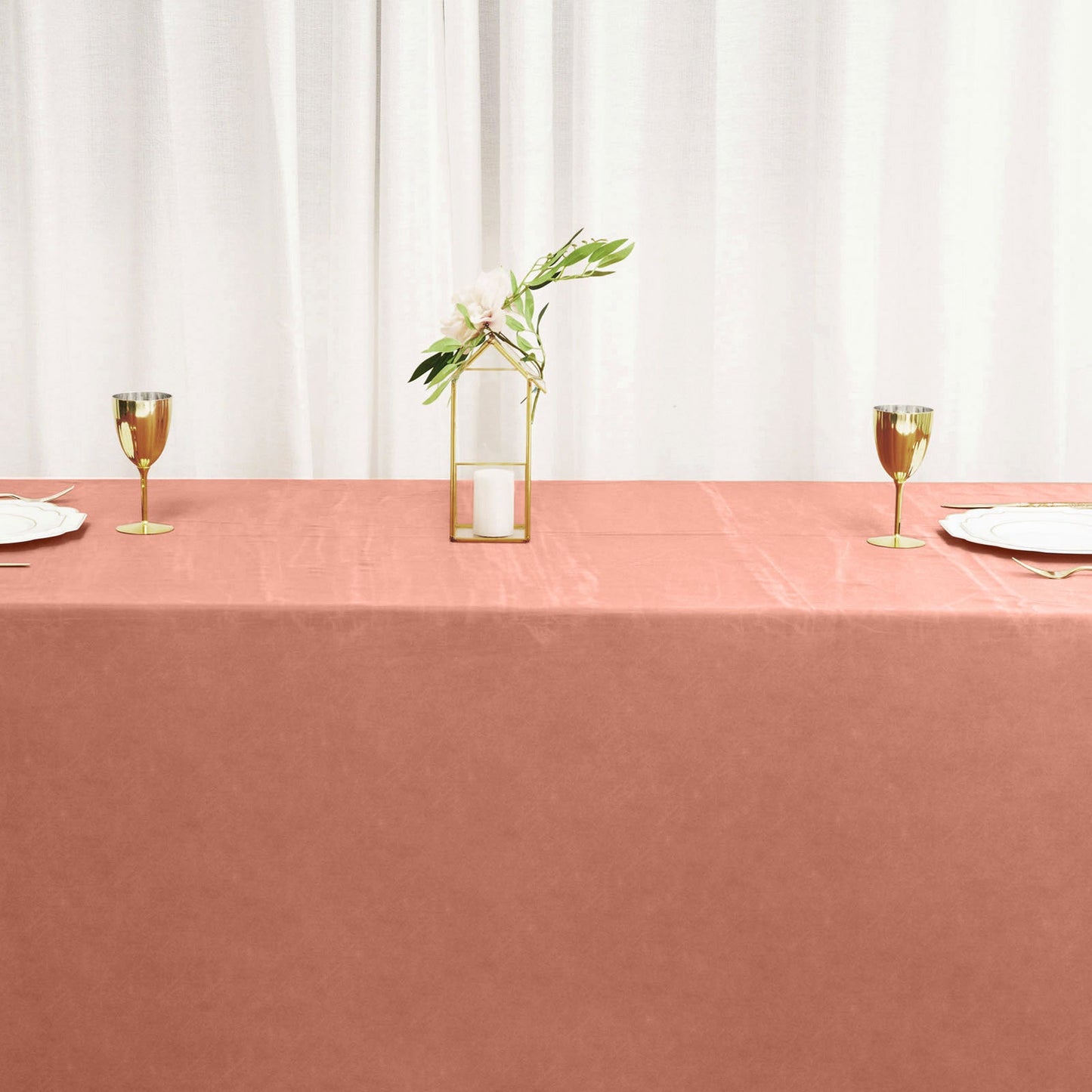Terracotta satin rectangular tablecloth on a dining table.
