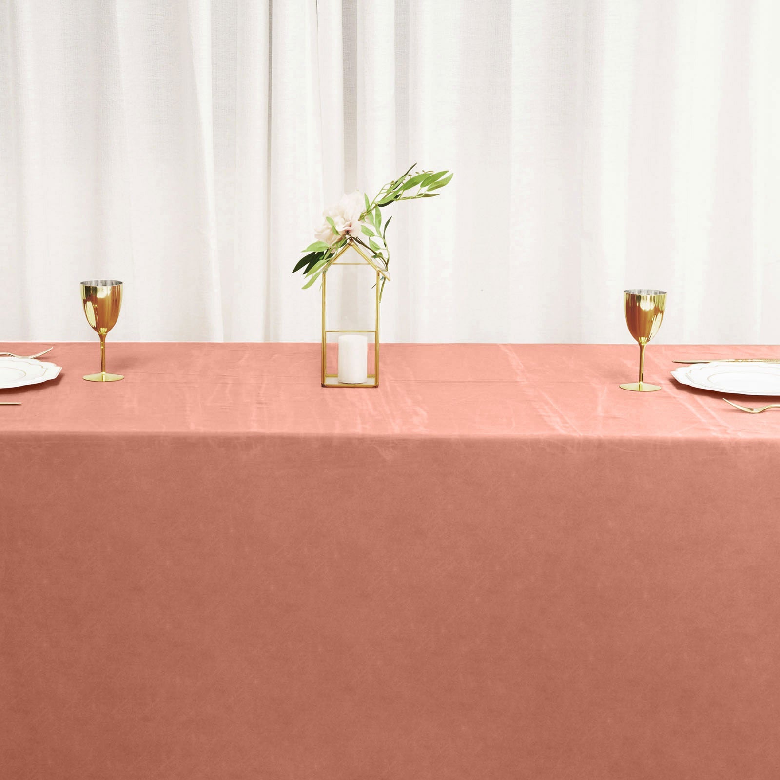 Terracotta satin rectangular tablecloth on a dining table.