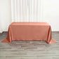 Terracotta satin rectangular tablecloth on a wooden floor.