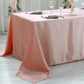 Dusty rose satin rectangular tablecloth on a dining table.