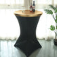 Metallic gold fitted cocktail table cover on a black table.