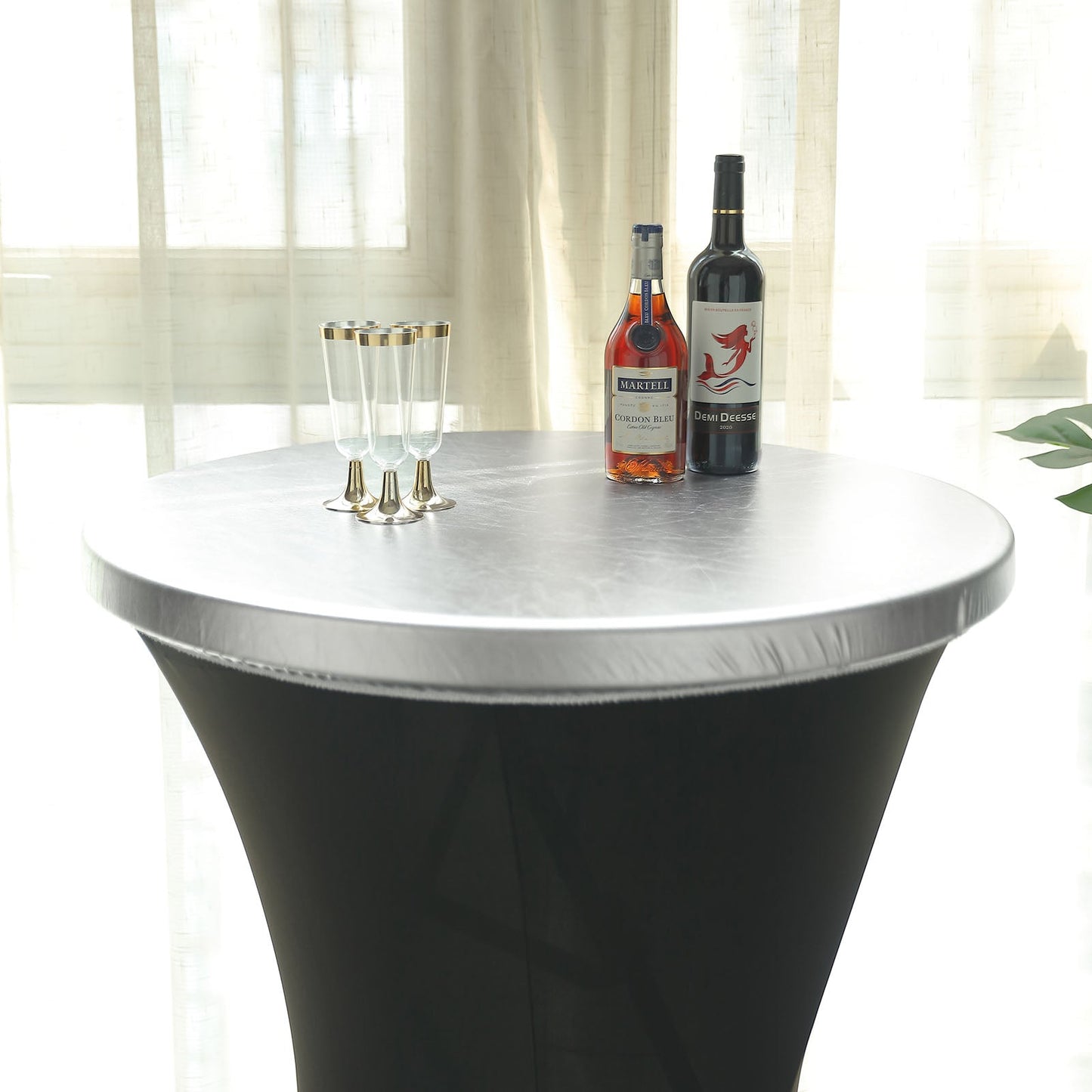 Metallic silver spandex stretch fitted cocktail table cover on a round table.