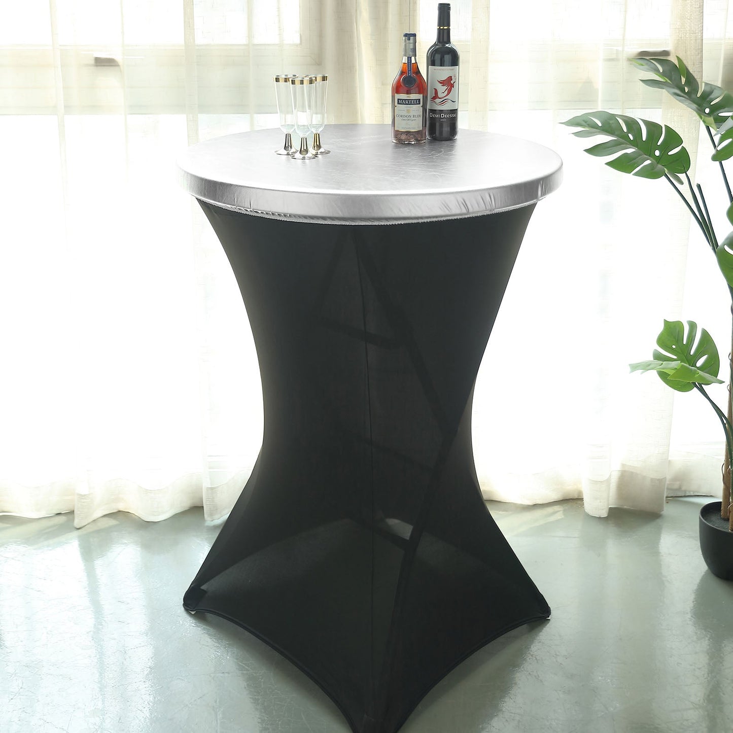 Metallic silver cocktail table cover on a fitted black table.