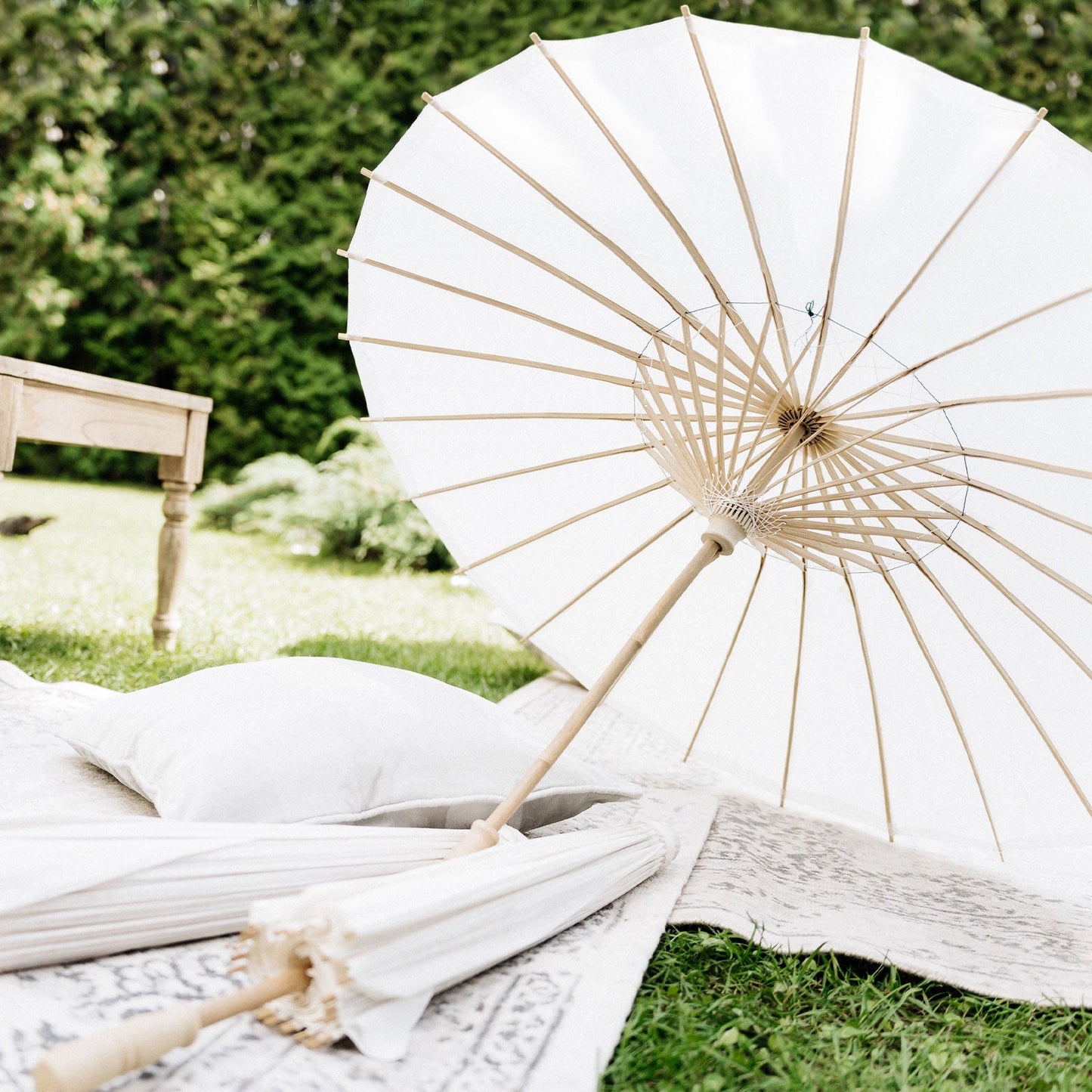 White bamboo parasol umbrella for weddings and events, perfect for table decorations.
