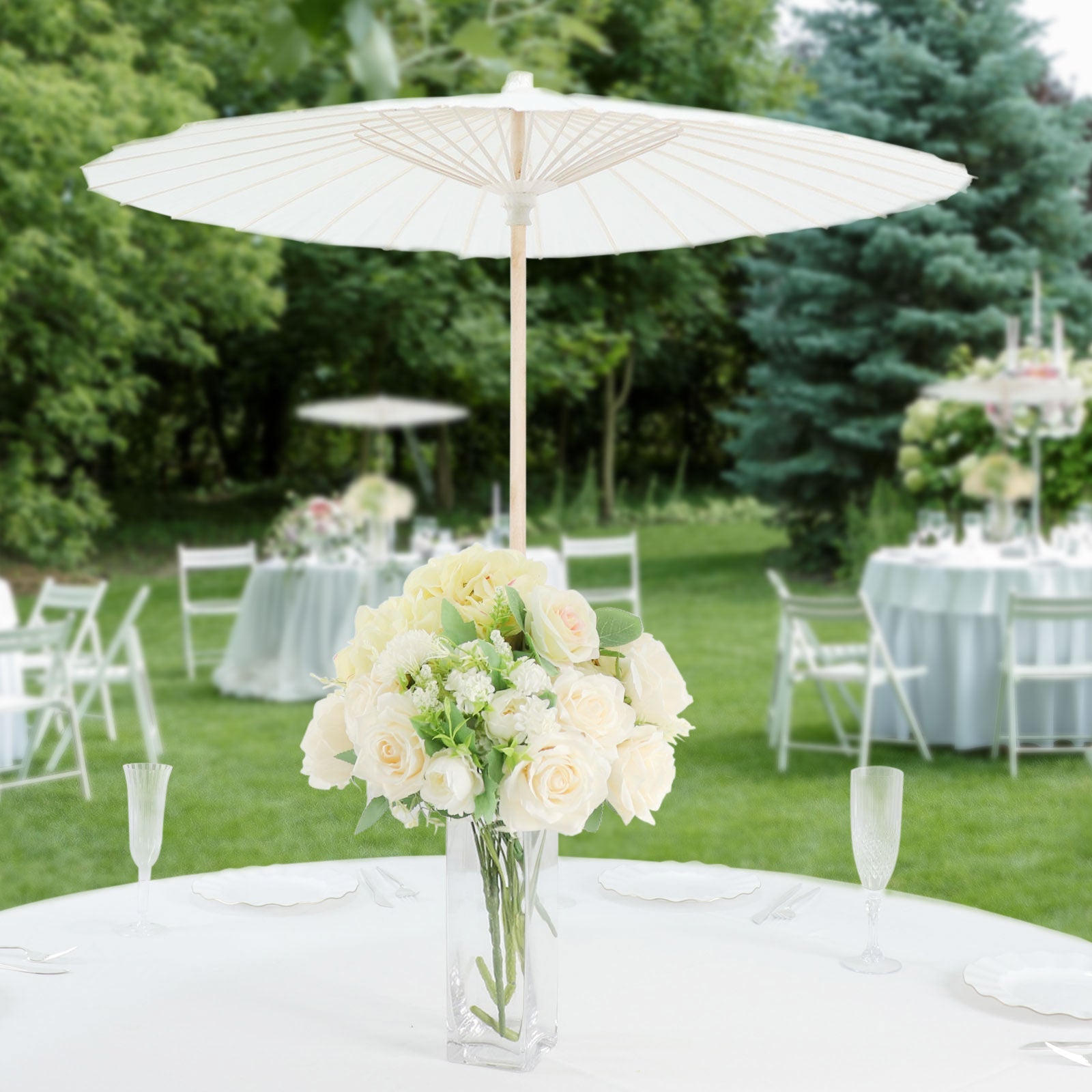 White parasol umbrella centerpiece with flowers at a wedding reception.