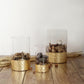 Set of 3 clear glass vases with gold honeycomb bases, 6", 8", and 10" tall.