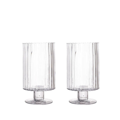 Clear ribbed glass vases, perfect for candles or floral arrangements.