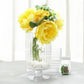 Clear ribbed pedestal glass vases with yellow flowers and decorative stones.