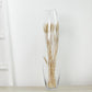 Clear vase with dried wheat stems, perfect for home decor.