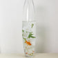 Elegant vase with water, white flowers, and a goldfish for a serene decor.