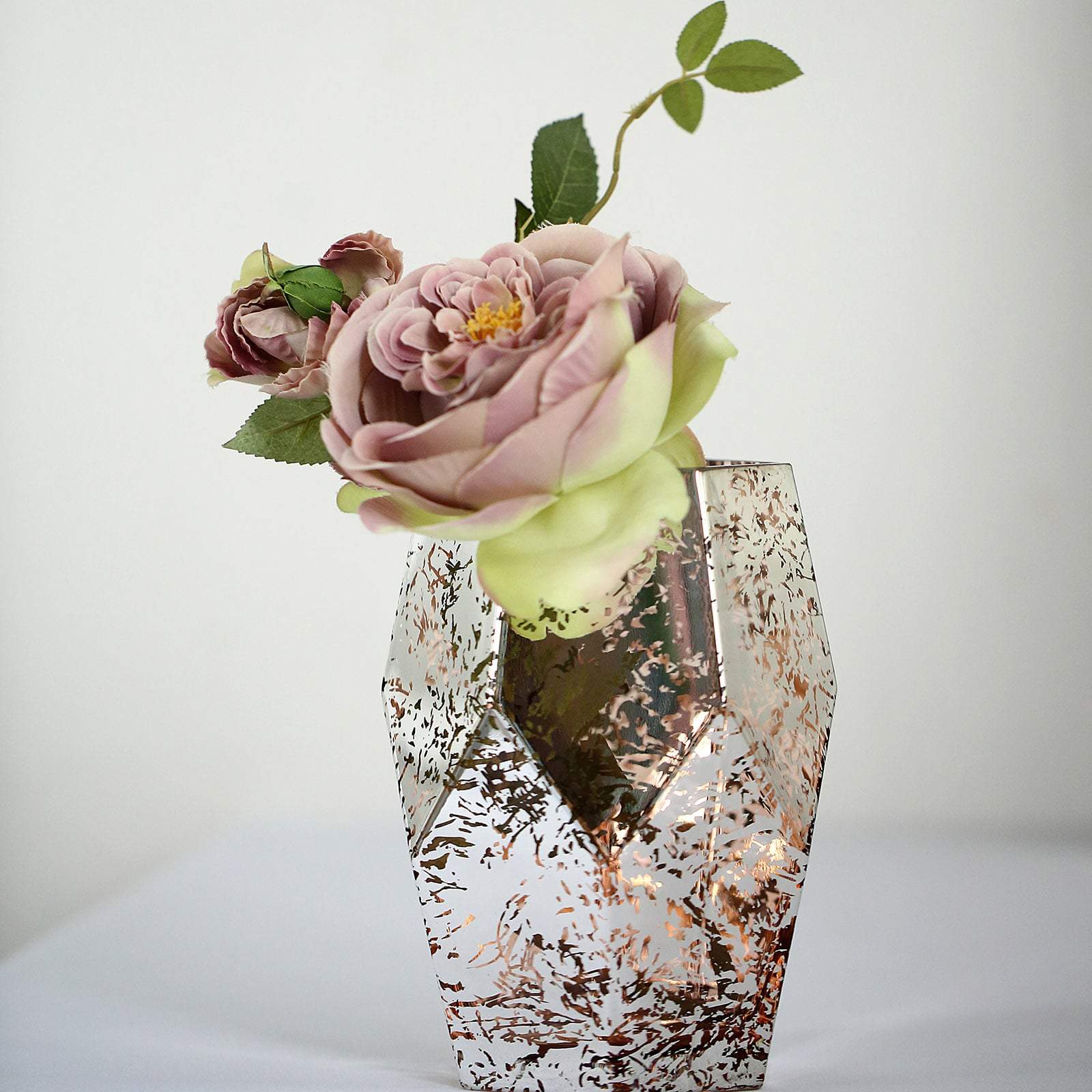Rose gold geometric vase with flowers.