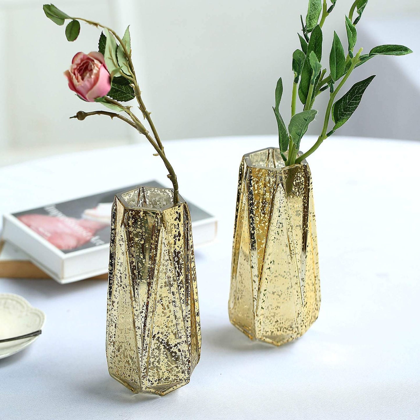 Gold geometric vases with flowers, perfect for centerpieces and decor.