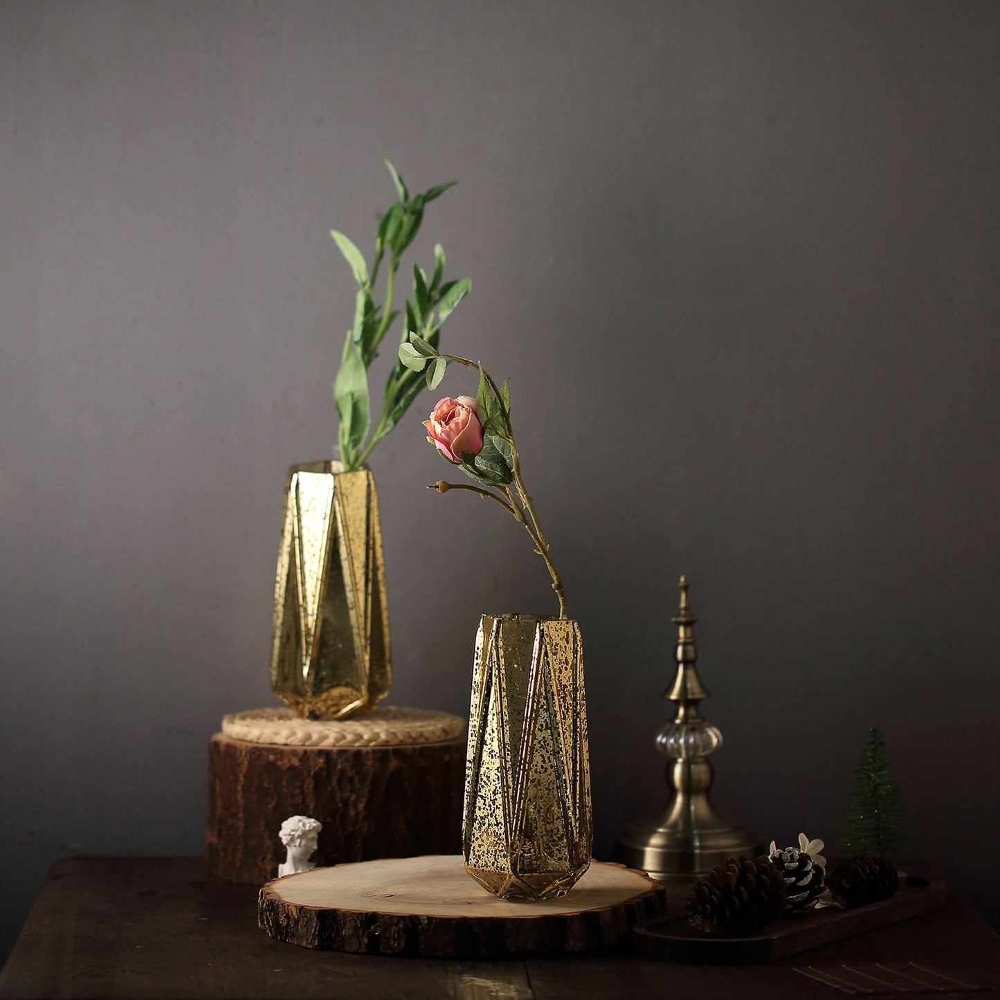 Gold geometric vases with flowers for elegant centerpieces.