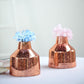 Rose gold mercury glass vases with blue and pink flowers.