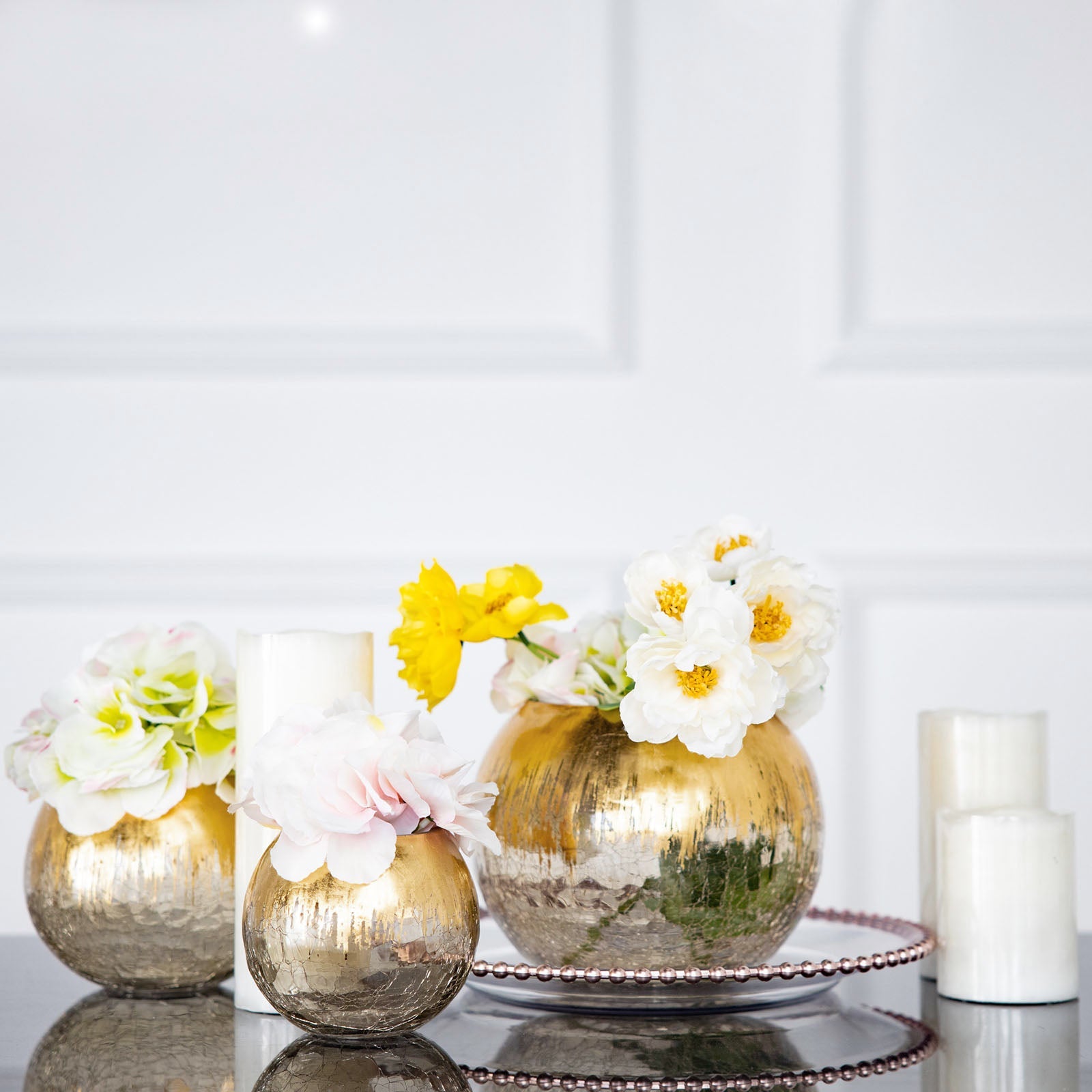 Gold foiled crackle glass bubble vase with flowers.