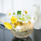 Gold foiled crackle glass bubble vase with white and yellow flowers.