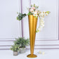 Brushed gold metal trumpet flower vase with floral arrangement.