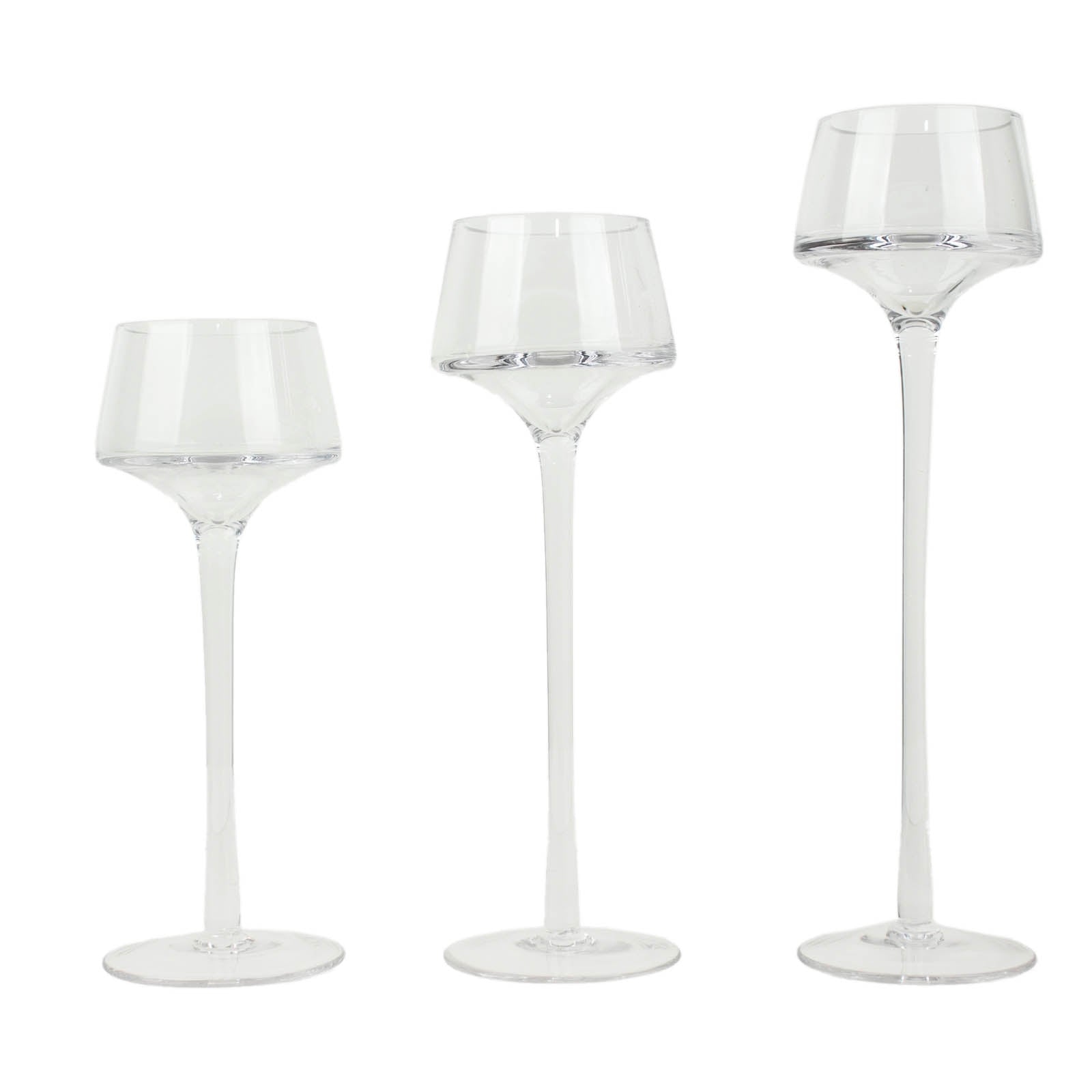 Clear glass tealight disc candle holders in varying heights.