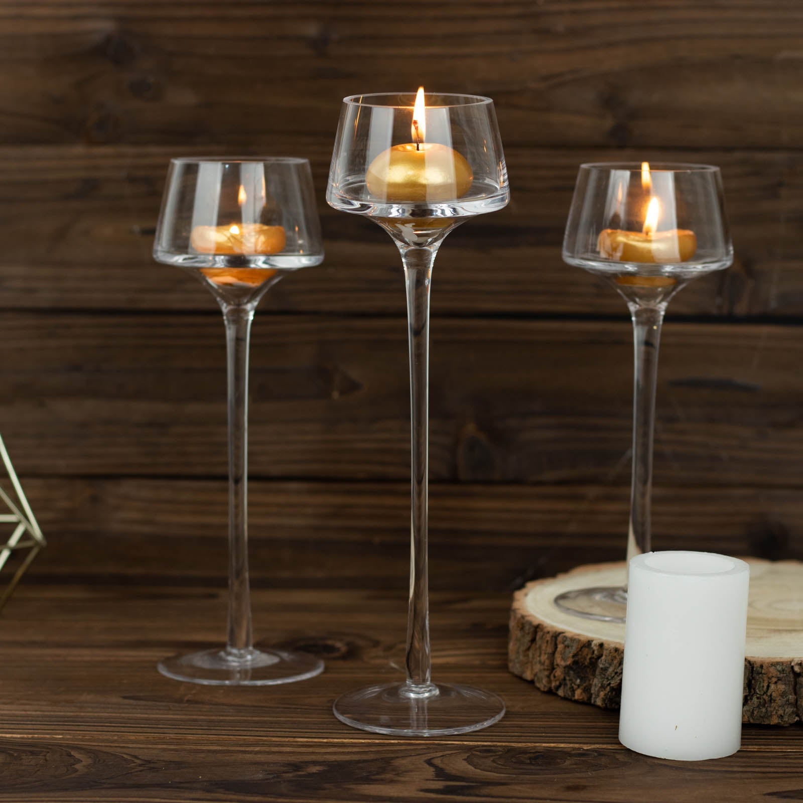Clear glass tealight candle holders in a tall pedestal design.