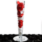 Clear heavy duty trumpet glass vase with red and white flower petals.