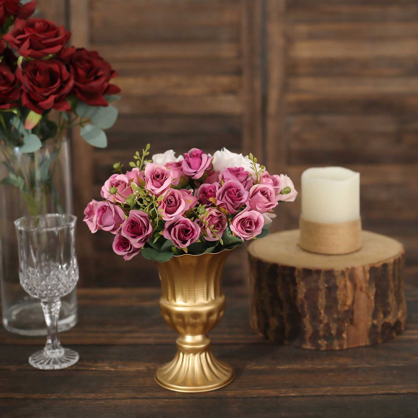 Gold metal trumpet-style flower vase with pink roses.