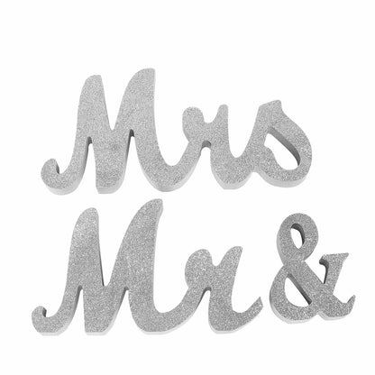 Silver glittered "Mr & Mrs" wooden photo props for wedding displays.