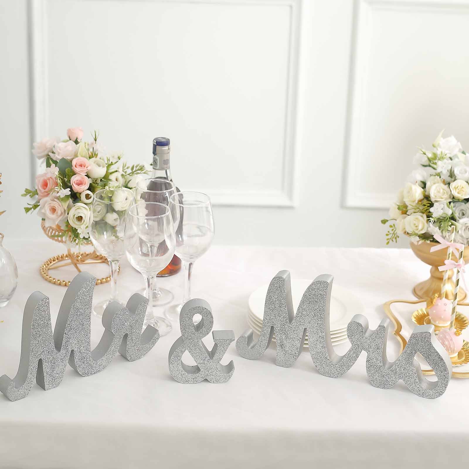 Silver glittered "Mr & Mrs" table display signs for weddings.