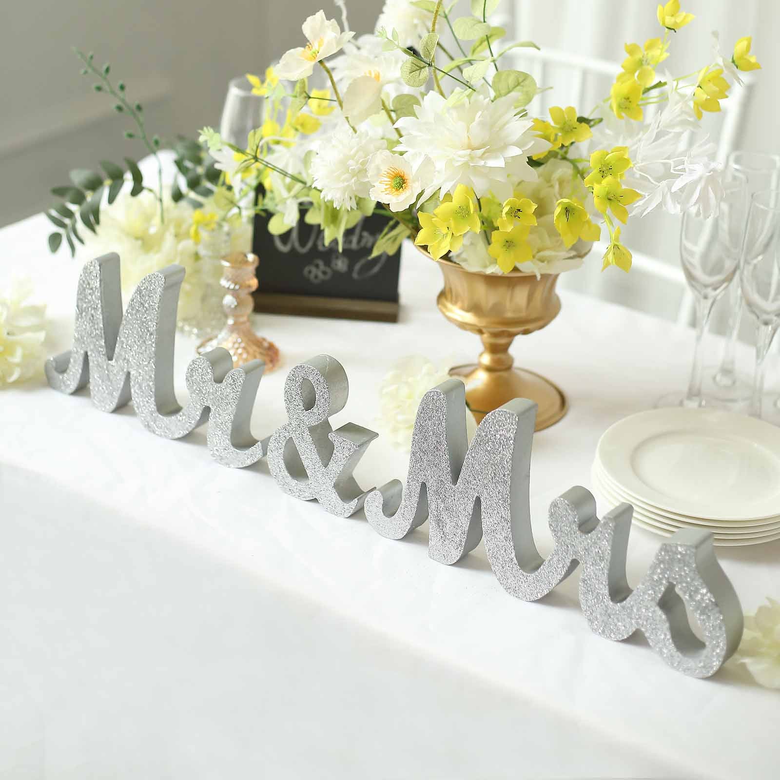 Silver glittered "Mr & Mrs" freestanding letters for wedding table display.