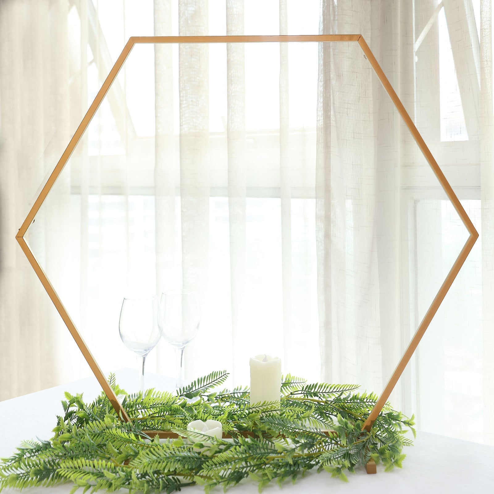 24" gold metal hexagon wedding arch centerpiece with greenery.