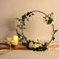 Silver round arch wedding centerpiece with greenery and white roses.