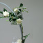 Silver round arch wedding centerpiece with floral accents.