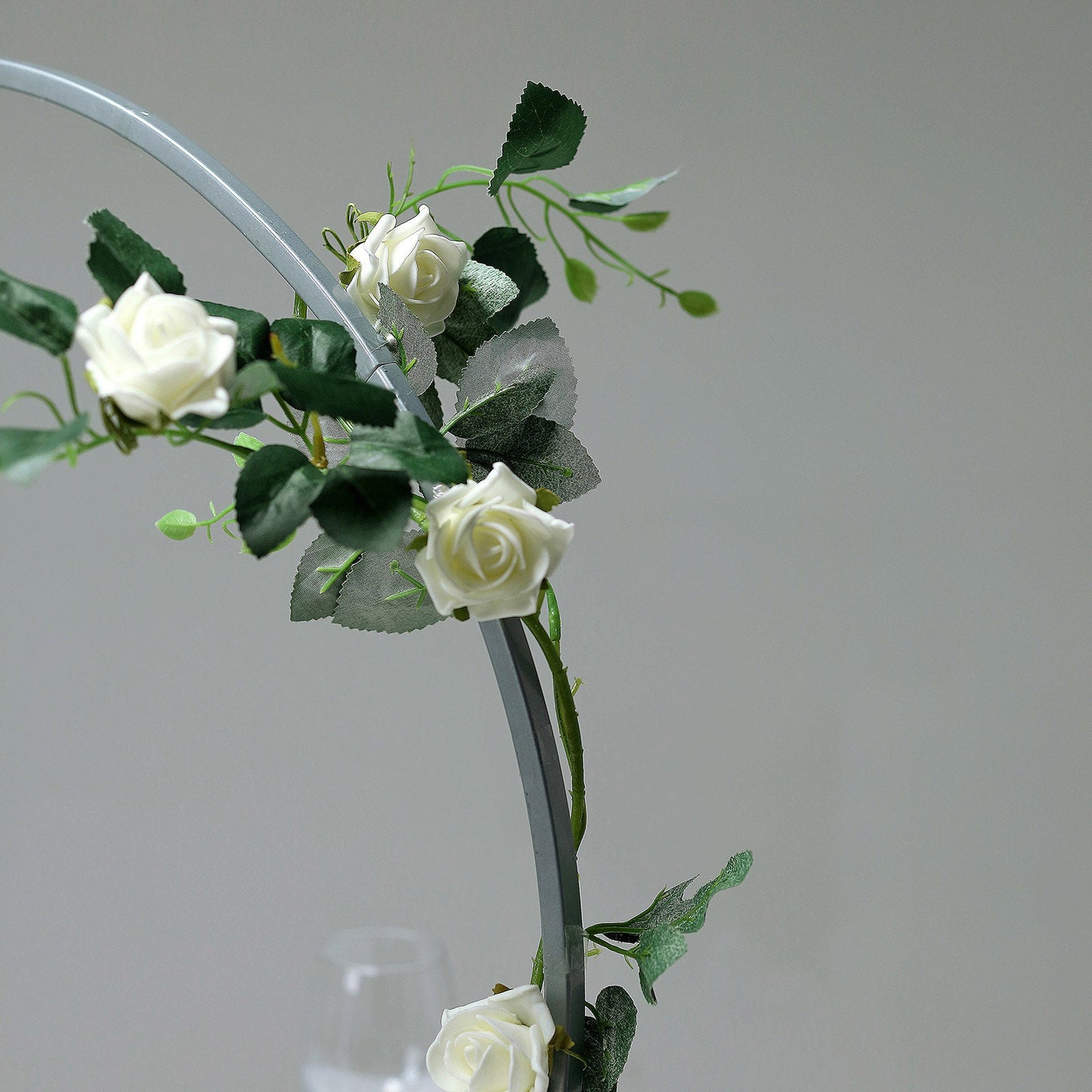 Silver round arch wedding centerpiece with floral accents.