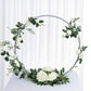 Silver round arch wedding centerpiece with white roses and greenery.