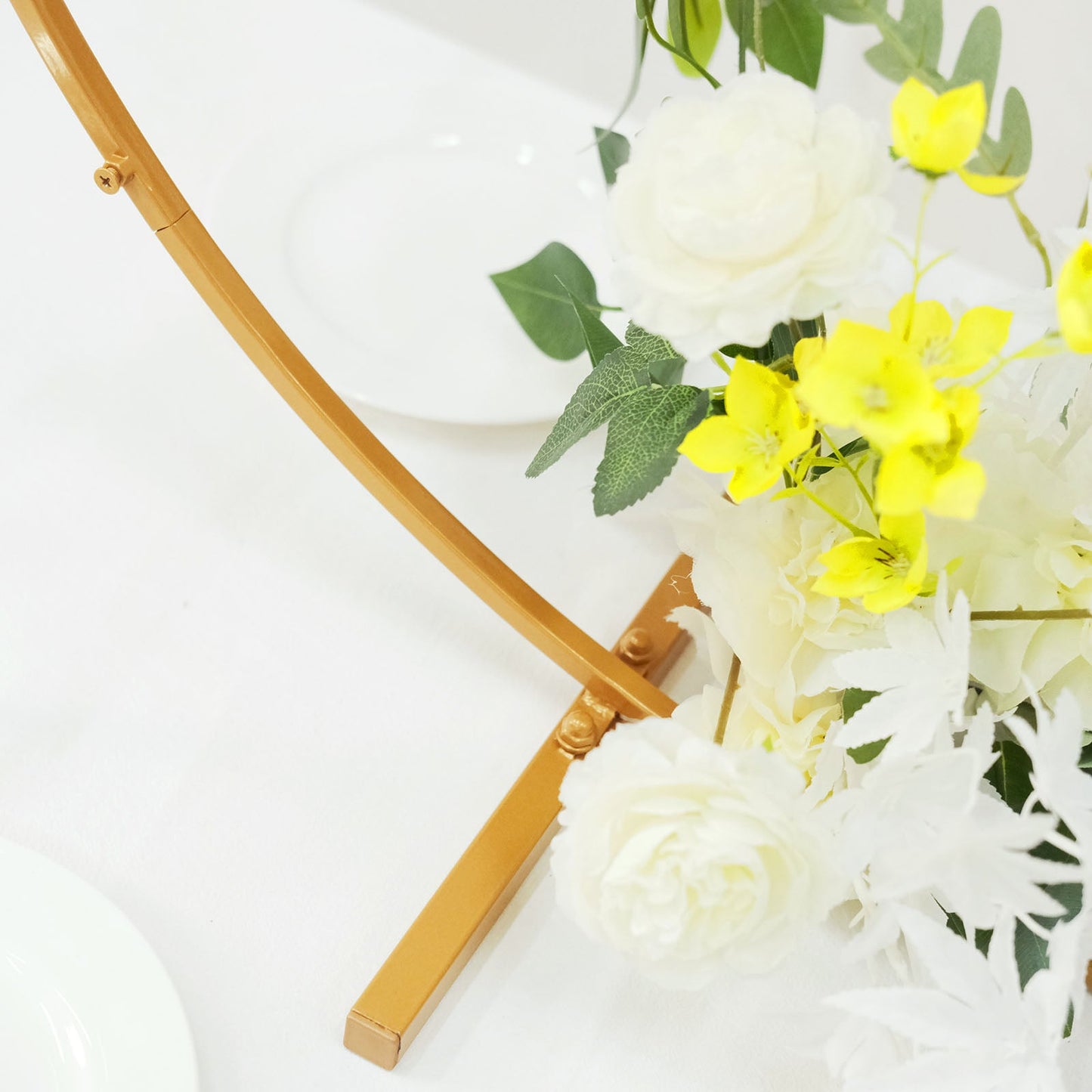 Gold metal round hoop wedding centerpiece with floral arrangements.